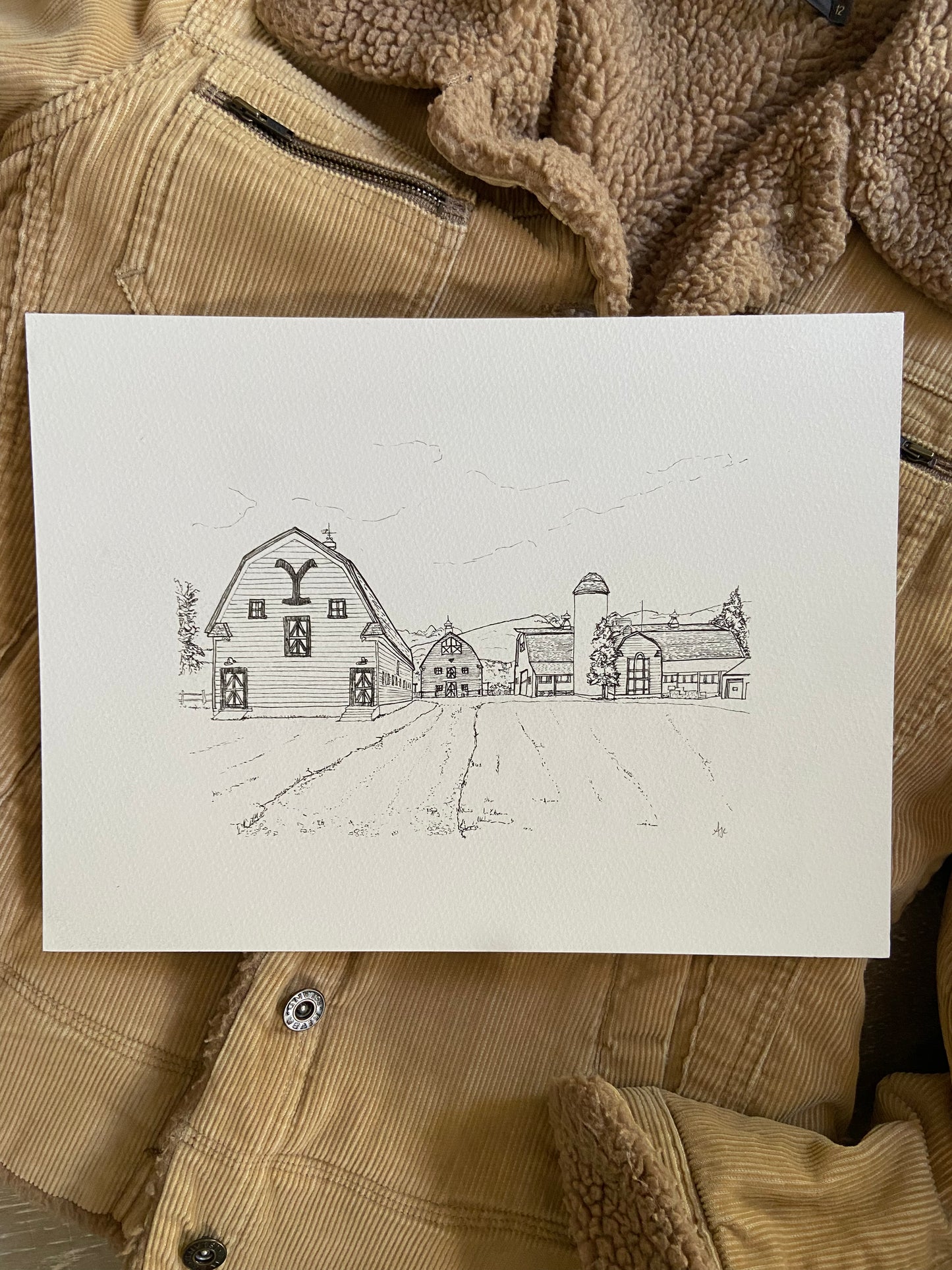 Black and white line drawing of a farm with barns and silos.