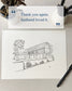 Note card with house illustration and text 'Thank you again, husband loved it.' on a textured surface.