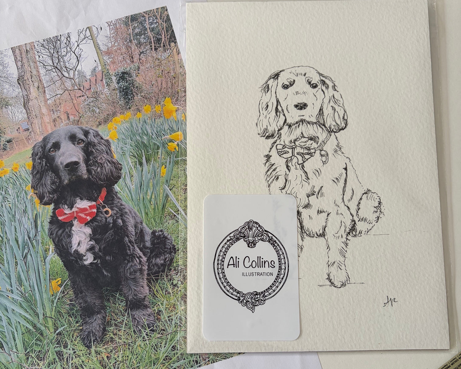 Greeting card with a dog illustration and a photo of a dog in flowers, on a wooden surface.