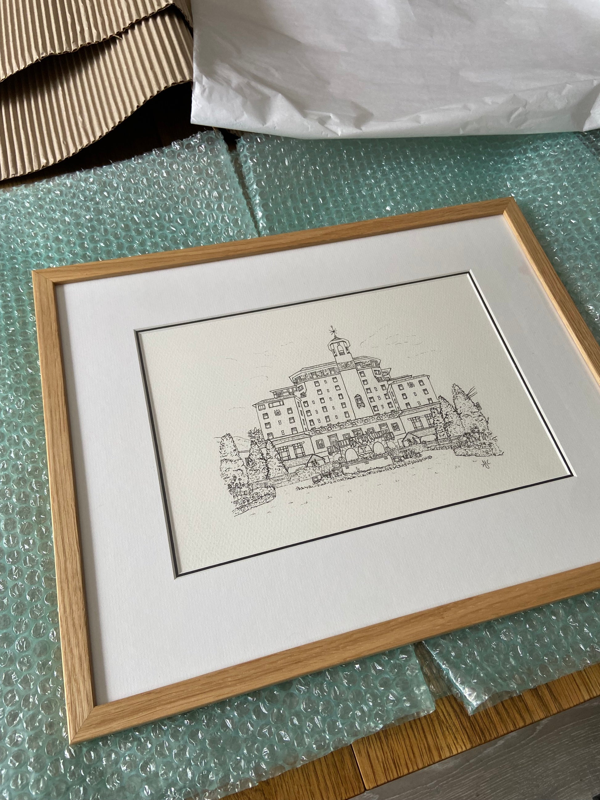 Framed hand-drawn Broadmoor wedding venue illustration with double mount by Ali Collins