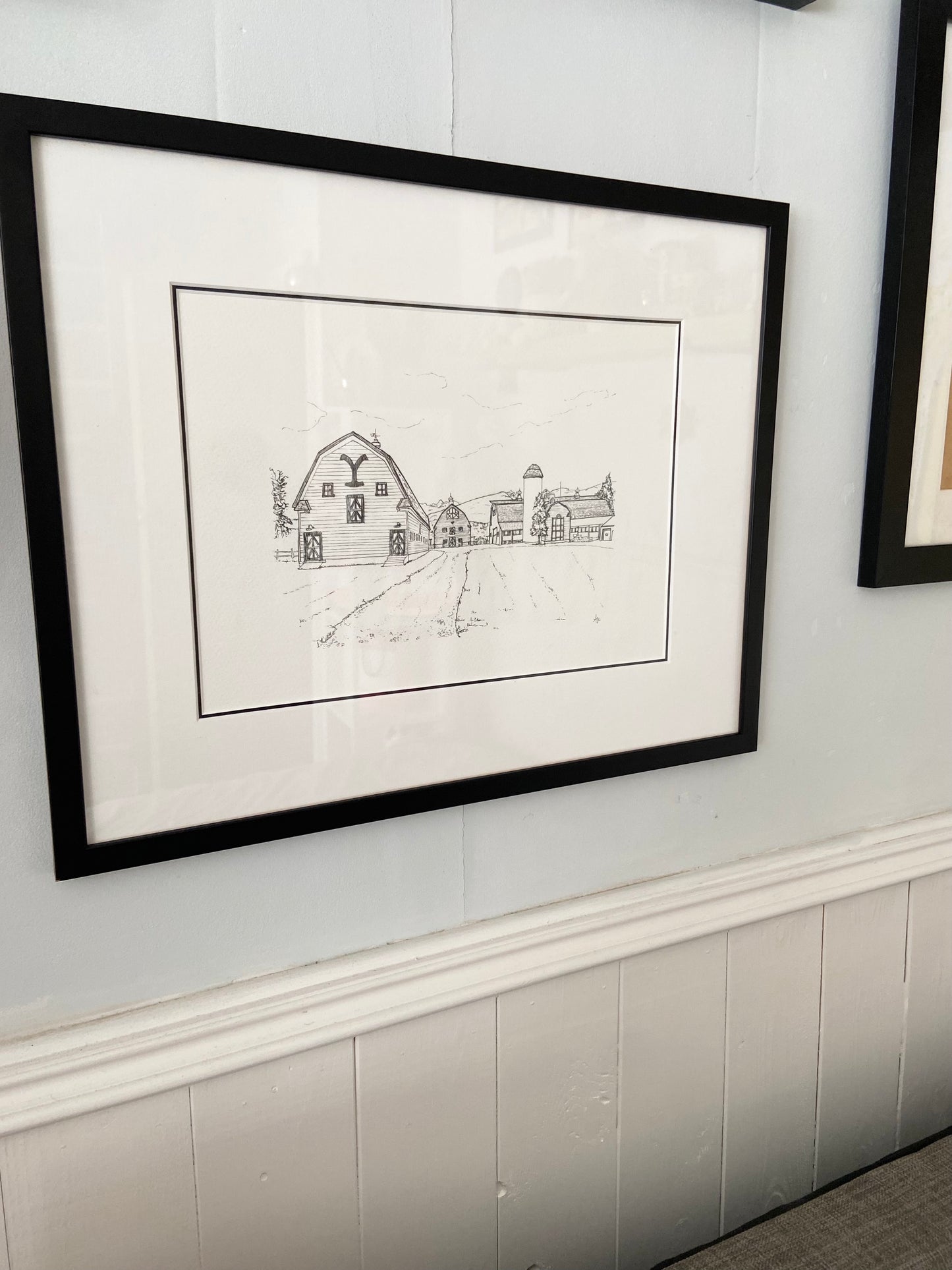 Framed Yellowstone barns illustration print in lifestyle setting — hand-signed original art by Ali Collins