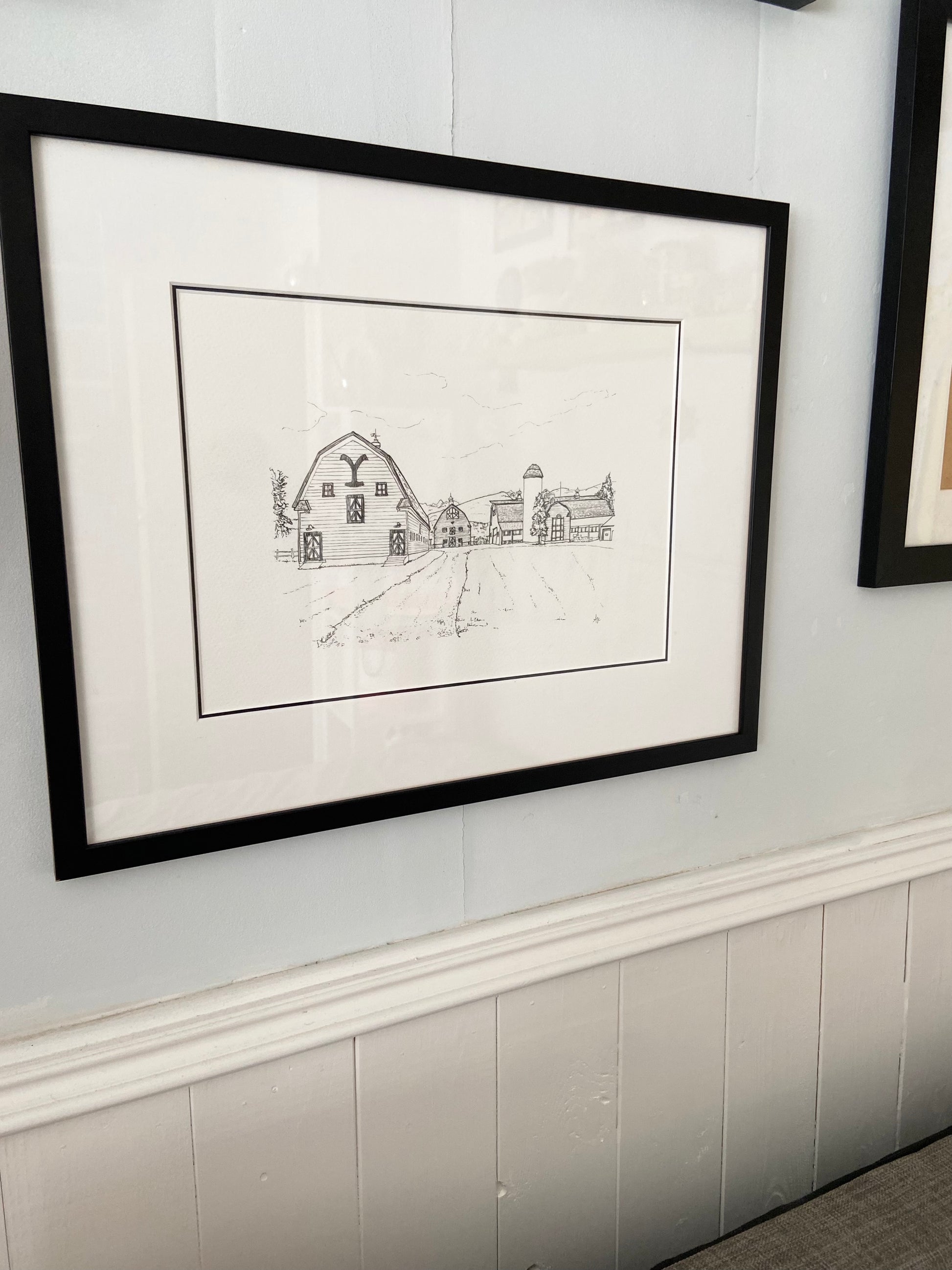 Framed Yellowstone barns illustration print in lifestyle setting — hand-signed original art by Ali Collins